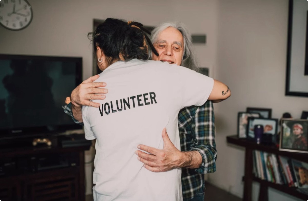 A volunteer embracing a woman